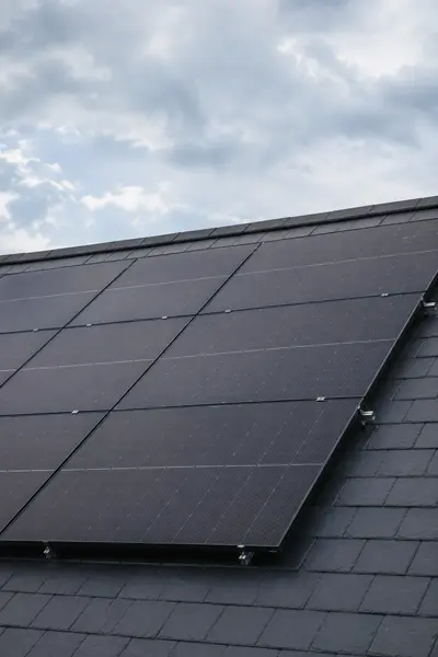 Close-up of black solar PV panels mounted on a pitched roof