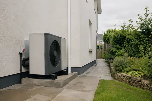 Air-to-water heat pump outdoor unit installed beside an Irish home