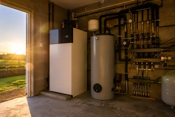 Heat pump indoor unit and hot water cylinder in a tidy plant room